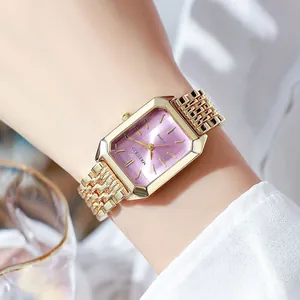 Close-up of elegant gold stainless steel rectangular watch with vibrant purple dial