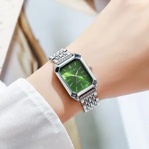 Close-up of an elegant square ladies watch with a sunburst green dial and silver strap