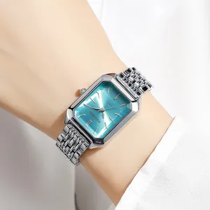 Detailed view of an elegant square ladies quartz watch with silver steel strap on a wrist