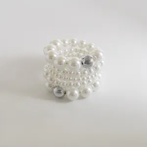 Detailed view of fashion multi-layered elastic pearl beaded bracelet with silver beads