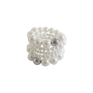 Detailed close-up of an elegant multi-row elastic pearl bracelet with silver bead accents.