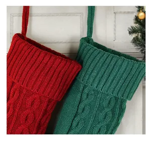Close-up view of red and green cable knit Christmas stockings featuring soft yarn texture