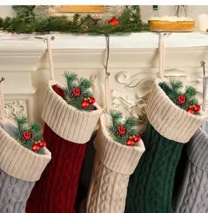 Close-up of colorful cable knit Christmas stockings hanging on a white fireplace mantel.