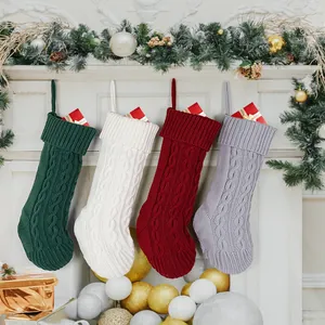 Set of four knitted cable knit Christmas stockings in festive colors for holiday decor