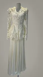 Elegant white lace two-piece set featuring a peplum top and a matching long pleated skirt