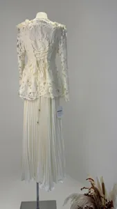 Detailed back view of cream lace top with waist lace-up and pleated maxi skirt