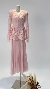 Detailed view showing the intricate pink lace top and long pleated skirt two-piece set