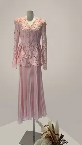 Elegant pink lace two-piece set featuring waisted top and pleated long skirt detail