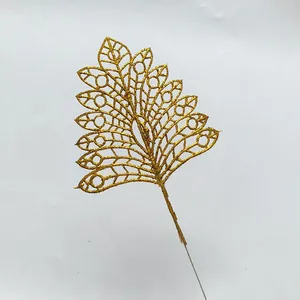Detailed view of a golden glitter artificial leaf for Christmas tree decoration.