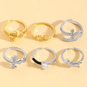 Detailed view of six assorted open-end rings with zircon and unique design motifs