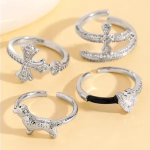 Silver-toned open ring set with CZ heart, cross, and dog motifs for women's accessory detail.