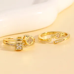 Detailed shot of two gold-plated copper adjustable rings with CZ Mom and floral patterns