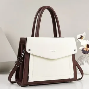 Elegant close-up of a two-tone brown and white PU leather handbag with silver hardware