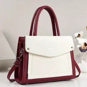 Detail shot of the contrast burgundy and white PU leather tote bag with top handle
