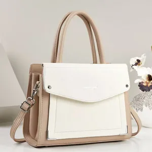 Detailed view of an elegant color-block PU leather handbag with silver hardware detail