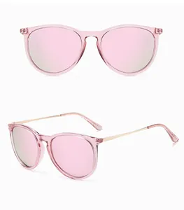 Detail view of retro pink cat-eye sunglasses with gold metal temples and mirror lenses