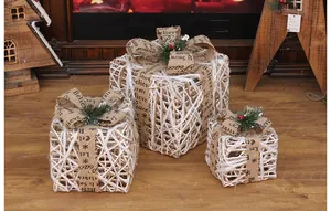 Set of three white woven Christmas gift boxes with decorative burlap ribbons for decor