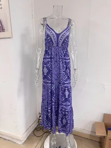 Detail view of a bohemian purple floral maxi dress with V-neck on a clear plastic mannequin.