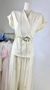Close-up of sleeveless blazer vest and matching straight trousers with braided belt
