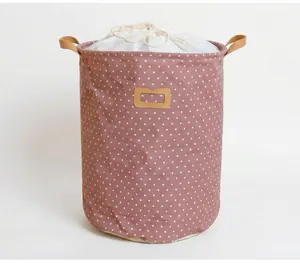 Collapsible cotton linen laundry basket with pink polka dot pattern and leather handles