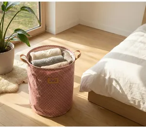 Foldable linen fabric laundry basket with polka dot pattern in a warm home setting