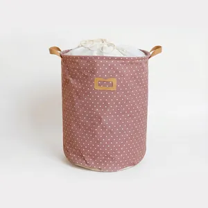 Large pink polka dot cotton linen laundry basket with drawstring top and leather handles
