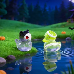 Set of miniature Halloween themed duck ornaments displayed on a mossy pond background
