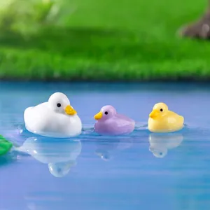 Three colorful miniature duck figurines floating on water for micro landscape DIY decor