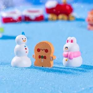 Miniature Christmas figurines featuring a snowman, gingerbread man, and rabbit for DIY decor.