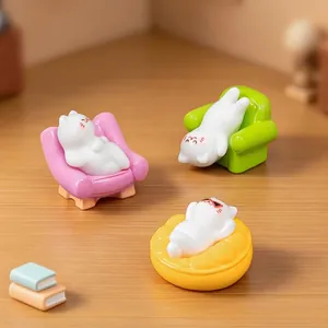 Set of cute miniature cat figurines lounging on colorful sofas for dollhouse decor