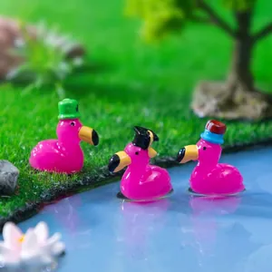 Three miniature pink flamingo figurines with different hats for micro landscape garden DIY decor
