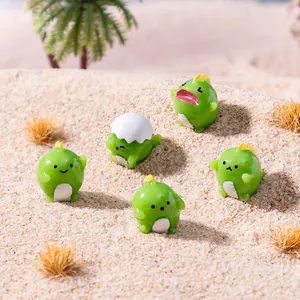 Set of 5 cute green dinosaur figurines on sand for creative micro landscape decor