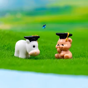 Miniature cow and bear figurines wearing graduation caps for DIY micro landscape decor