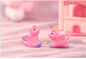 Detailed macro shot of two pink resin unicorn figurines for micro landscape decoration