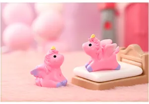 Detailed close-up view of two cute pink resin mini unicorns for micro landscape decor.