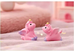 Detailed close-up view of two pink miniature resin unicorn figurines for fairy gardens