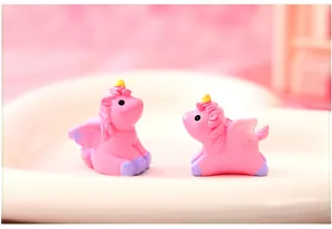Detail view of two pink mini resin unicorn figurines for garden micro landscape decor
