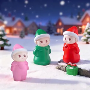 Three cute miniature doll figurines in a winter snow landscape for DIY decoration