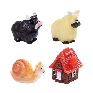 Set of 4 resin farm figurines including hairy cows, snail and miniature house