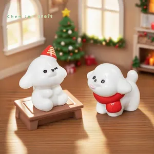 Two cute miniature white dog figurines with Christmas scarf and hat for DIY dollhouse decor.