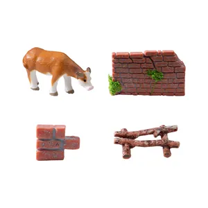 Set of miniature farm accessories including cow figurine, brick walls, and wooden fence