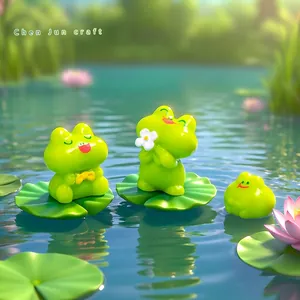 Süße Mikro-Landschaft Froschfiguren auf grünen Seerosenblättern für DIY Gartendeko.