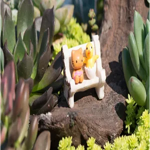 Detailed macro view of a white resin miniature bench in a succulent micro landscape