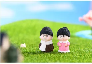 Dettaglio di figurine di coppia di anziani in abiti invernali per micro-paesaggi fai-da-te
