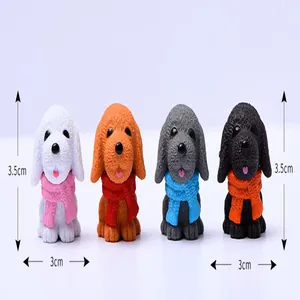 Detailed size view of four resin puppy figurines with colorful scarves