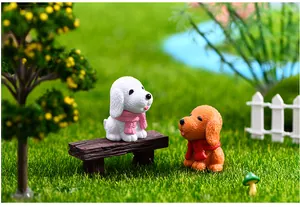 High-quality detailed shot of miniature resin dog figurines wearing colorful scarves in a garden