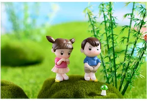 Detailed close-up of cute boy and girl couple figurines for moss micro landscape