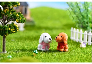 Miniature resin puppy figurines with scarves in micro landscape garden setting