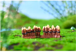 Close-up macro view of miniature resin fence ornaments for moss micro-landscape DIY decor
