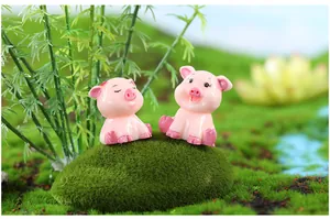 Detailed view of two cute pink resin pig figurines for miniature garden decor
